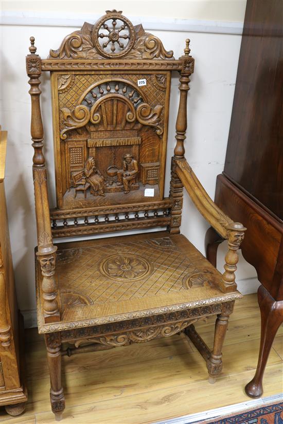 A 19th century French oak Renaissance style elbow chair, the back panel carved with an interior scene after David Teniers